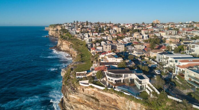 Aerial view of residential area across rock cliff area in Sydney coastline